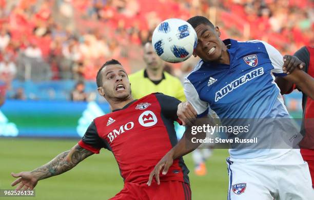 Toronto FC forward Sebastian Giovinco and FC Dallas defender Reggie Cannon battle for a ball as Toronto FC plays FC Dallas in Toronto. May 25, 2018.