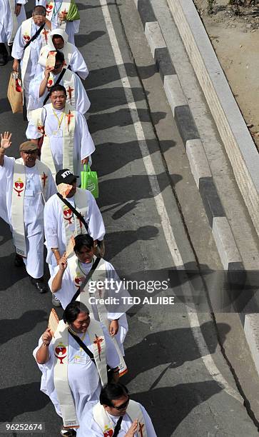 Roman Catholic priests march on the streets of Manila on January 29 on their way to a stadium to celebrate mass at the conclusion of their congress....