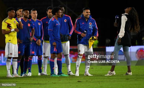 Colombian national football team players smile with Colombian athlete Caterine Ibarguen during the farewell exhibition game ahead of the upcoming...