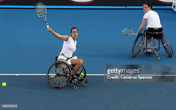 Florence Gravellier of France plays a backhand in her Women's Wheelchair Doubles final match with Aniek van Koot of the Netherlands against Lucy...