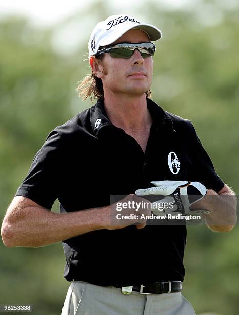 Brett Rumford of Australia takes off his glove on the eighth hole during the second round of the Commercialbank Qatar Masters at Doha Golf Club on...