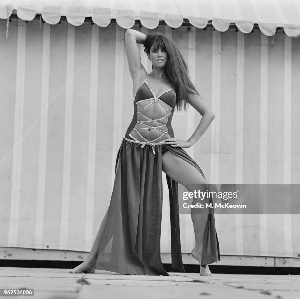 English model and actress Caroline Munro wears a swimsuit teamed with a hipster skirt on 5th October 1970.