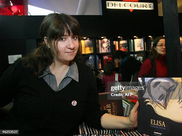 Nathalie Ferlut, French cartoonist of the comic book "Elisa" poses on January 28, 2010 on the Delcourt editions stand during the 37th edition of the...