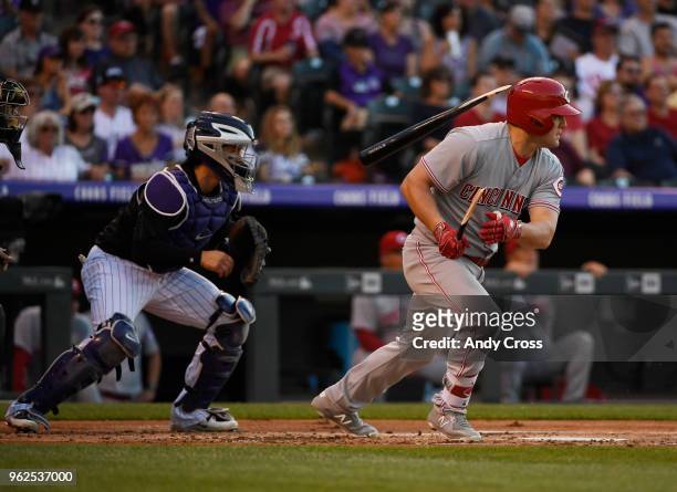 Cincinnati Reds right fielder Scott Schebler hits a broken-bat RBI single scoring Cincinnati Reds first baseman Joey Votto against Colorado Rockies...