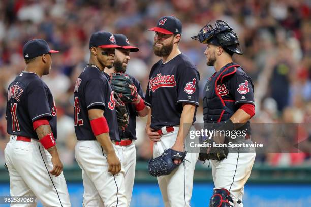 Cleveland Indians starting pitcher Corey Kluber on the mound with Cleveland Indians third baseman Jose Ramirez , Cleveland Indians shortstop...