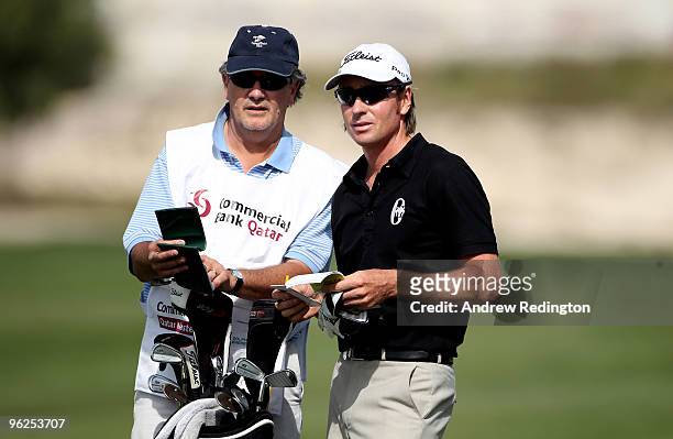 Brett Rumford of Australia waits with his caddie on the ninth hole during the second round of the Commercialbank Qatar Masters at Doha Golf Club on...