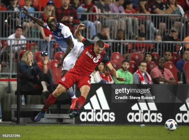 Dallas forward Roland Lamah battles Toronto FC defender Nick Hagglund for a header as Toronto FC falls FC Dallas 1-0 at BMO Field in Toronto. May 25,...