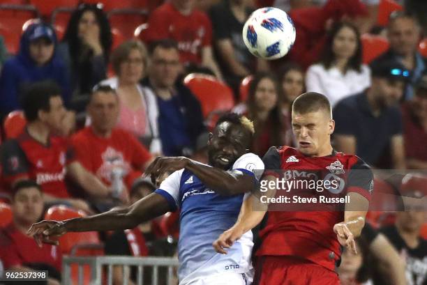 Dallas forward Roland Lamah battles Toronto FC defender Nick Hagglund for a header as Toronto FC falls FC Dallas 1-0 at BMO Field in Toronto. May 25,...