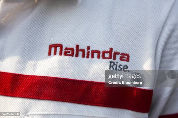 Logo is displayed on the uniform of an employee at the Mahindra & Mahindra Ltd. Facility in Chakan, Maharashtra, India, on Tuesday, April 3, 2018....
