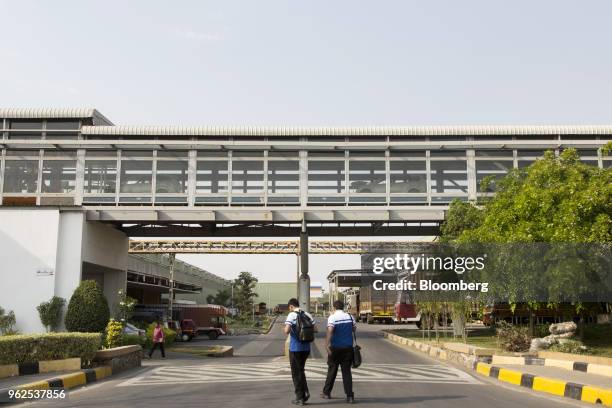 Employees walk through the Mahindra & Mahindra Ltd. Facility in Chakan, Maharashtra, India, on Tuesday, April 3, 2018. Mahindra & Mahindra is Indias...