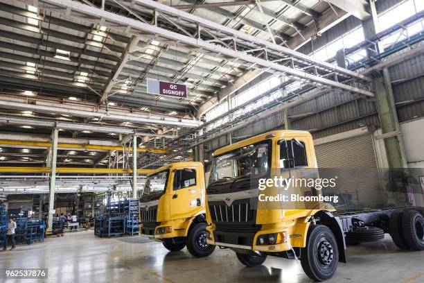 Trucks sit parked in the heavy vehicle assembly line of the Mahindra & Mahindra Ltd. Facility in Chakan, Maharashtra, India, on Monday, April 2,...