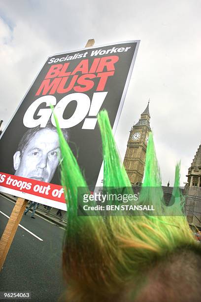 Demonstrator holds a placard against British Prime Minister Tony Blair during an Anti war demonstration to mark the third anniversary of the invasion...