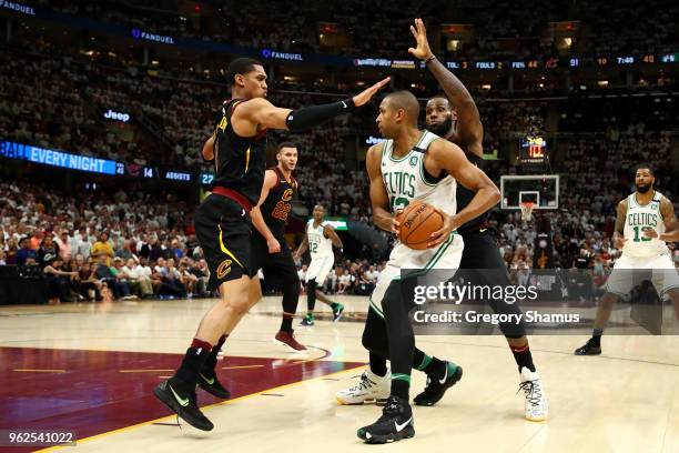 Al Horford of the Boston Celtics handles the ball against Jordan Clarkson and LeBron James of the Cleveland Cavaliers in the fourth quarter during...