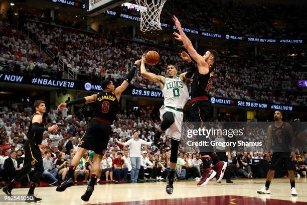 Kevin Love of the Cleveland Cavaliers drives to the basket against Jordan Clarkson and Larry Nance Jr. Of the Cleveland Cavaliers in the fourth...