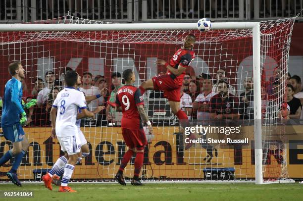 Ryan Telfer heads a ball away from the net as Toronto FC goalkeeper Clint Irwin watches as Toronto FC falls FC Dallas 1-0 at BMO Field in Toronto....