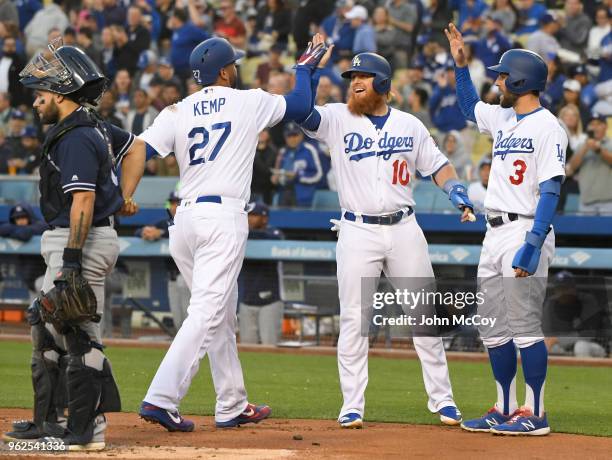 Matt Kemp of the Los Angeles Dodgers is congratulated by Justin Turner and Chris Taylor as Raffy Lopez of the San Diego Padres stands at the plate...