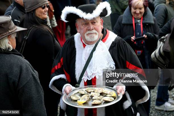 The town crier delivers a tray of oysters during the opening ceremony at the Bluff Oyster & Food Festival on May 26, 2018 in Bluff, New Zealand. The...