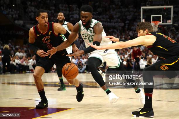 Jaylen Brown of the Boston Celtics handles hte ball against Jordan Clarkson and Kyle Korver of the Cleveland Cavaliers in the fourth quarter during...