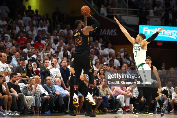 LeBron James of the Cleveland Cavaliers shoots a three point basket in the fourth quater against Jayson Tatum of the Boston Celtics during Game Six...