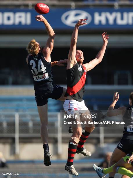 Andrew Phillips of the Blues and Matthew Leuenberger of Essendon compete for the ball during the round eight VFL match between the Northern Blues and...