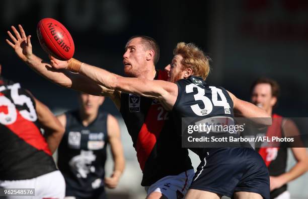 Andrew Phillips of the Blues and Matthew Leuenberger of Essendon compete for the ball during the round eight VFL match between the Northern Blues and...