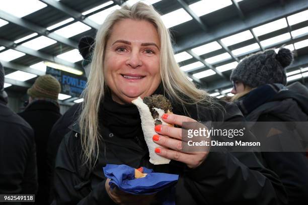 Festival goer tries a paua pattie sandwiche during the Bluff Oyster & Food Festival on May 26, 2018 in Bluff, New Zealand. The annual event aims to...