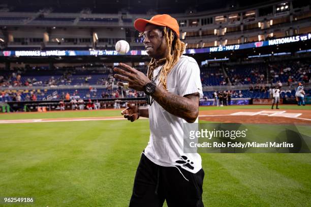 Rapper Lil Wayne throws out the ceremonial first pitch before the game between the Miami Marlins and the Washington Nationals at Marlins Park on May...