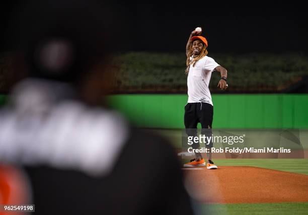 Rapper Lil Wayne throws out the ceremonial first pitch before the game between the Miami Marlins and the Washington Nationals at Marlins Park on May...