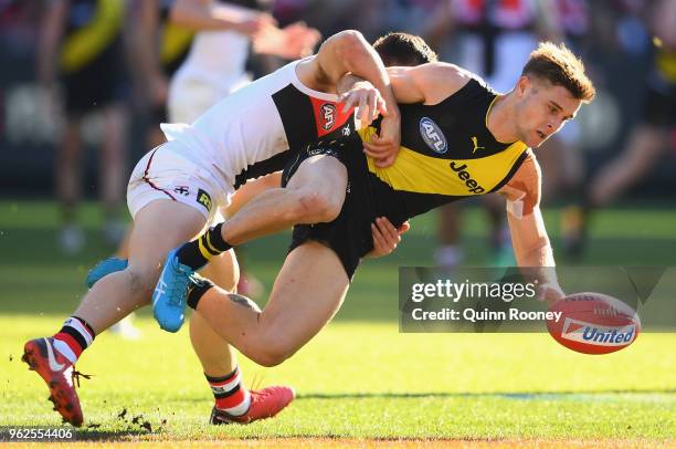 Jayden Short of the Tigers is tackled by Jade Gresham of the Saints during the round 10 AFL match between the Richmond Tigers and the St Kilda Saints...