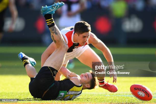 Jayden Short of the Tigers is tackled by Jade Gresham of the Saints during the round 10 AFL match between the Richmond Tigers and the St Kilda Saints...