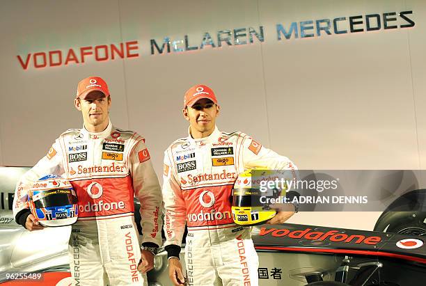 British Formula One drivers Jenson Button and Lewis Hamilton pose for photographs during the launch of the McLaren Mercedes MP4-25 Formula 1 racing...