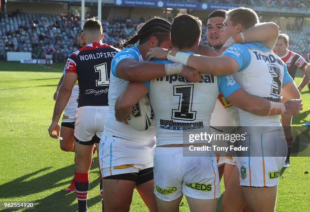 Titans players celebrate a try during the round 12 NRL match between the Sydney Roosters and the Gold Coast Titans at Central Coast Stadium on May...