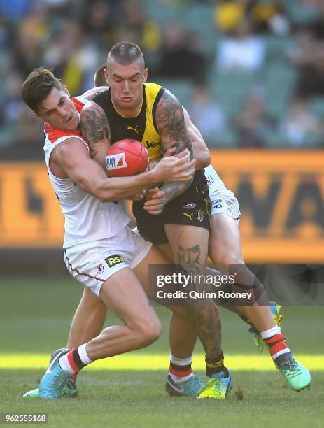 Dustin Martin of the Tigers is tackled by Jack Steele and Sebastian Ross of the Saints during the round 10 AFL match between the Richmond Tigers and...