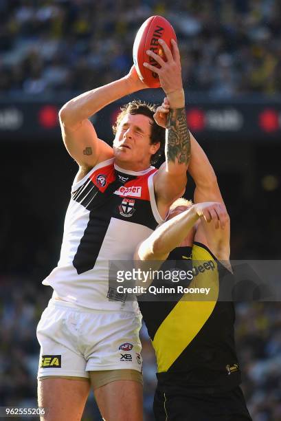 Jake Carlisle of the Saints marks over the top of Josh Caddy of the Tigers during the round 10 AFL match between the Richmond Tigers and the St Kilda...