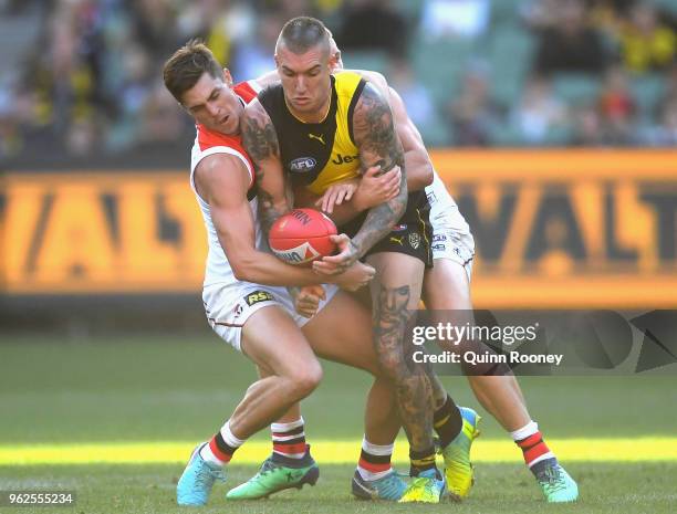 Dustin Martin of the Tigers is tackled by Jack Steele and Sebastian Ross of the Saints during the round 10 AFL match between the Richmond Tigers and...