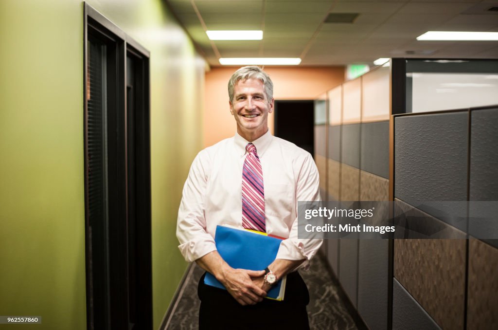 Caucasian man in an office hallway