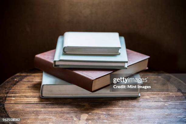 high angle close up of stack of book s on wooden table. - book on table foto e immagini stock