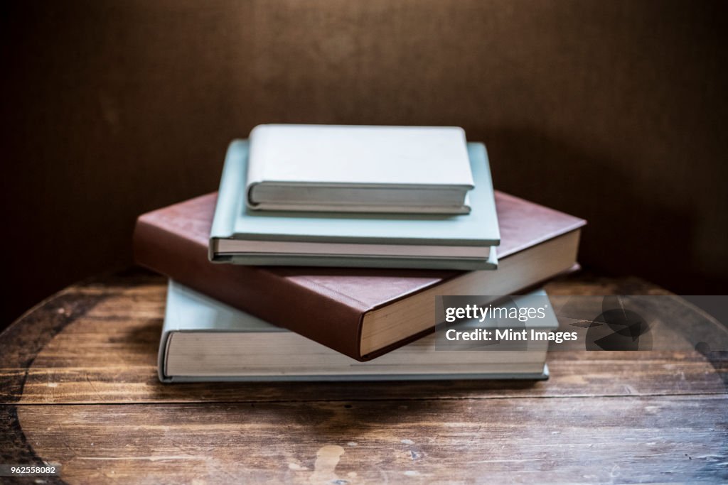 High angle close up of stack of book s on wooden table.