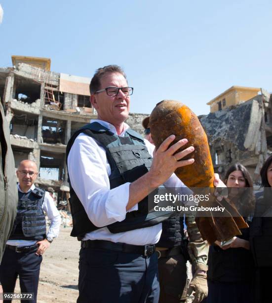 April 24: German Development Minister Gerd Mueller, CSU, holds a defused grenade in his hand. He visits the UNMAS detonator removal at Al Shifaa...