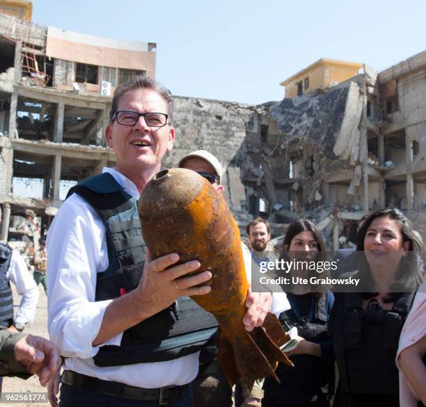 April 24: German Development Minister Gerd Mueller, CSU, holds a defused grenade in his hand. He visits the UNMAS detonator removal at Al Shifaa...