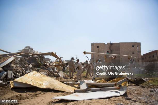 April 24: Cash for work. People rebuilding the ruined city of Mosul after liberation from IS on April 24, 2018 in MOSUL, IRAQ.