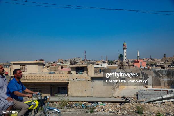 April 24: Two men on a motorcycle in the ruined old town in Mosul on April 24, 2018 in MOSUL, IRAQ.