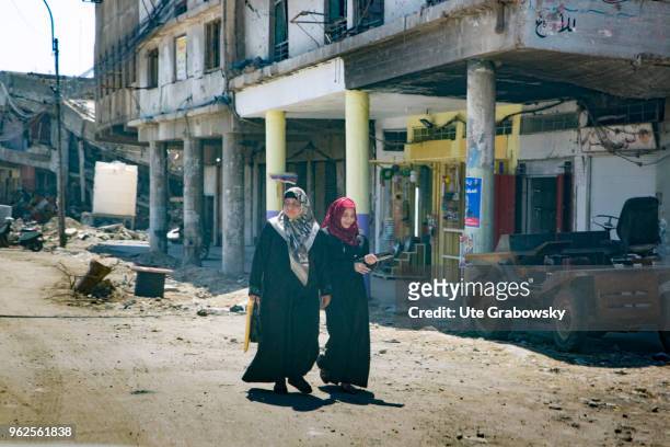 April 24: Two young women walk on a street in the destroyed old town in Mosul on April 24, 2018 in MOSUL, IRAQ.