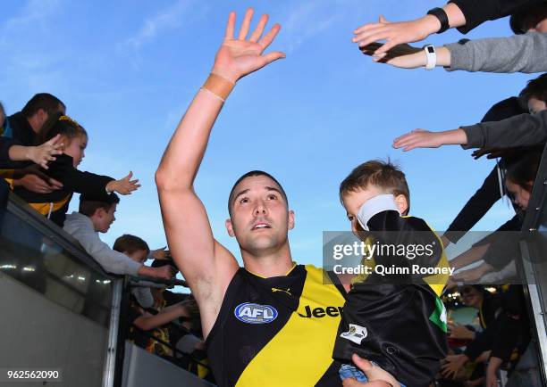 Shaun Grigg of the Tigers high fives fans after winning the round 10 AFL match between the Richmond Tigers and the St Kilda Saints at Melbourne...