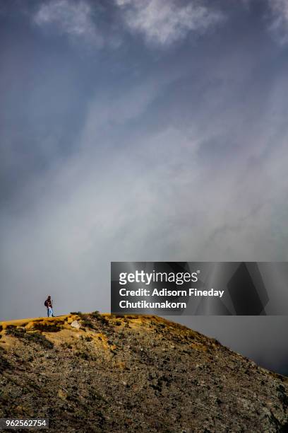 hikers walking against volcanic crater - sulfuric acid stock pictures, royalty-free photos & images