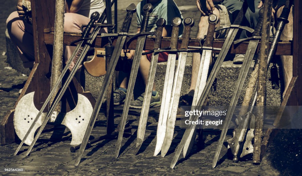 Swords set up in a row for the knight demonstration at a medieval market