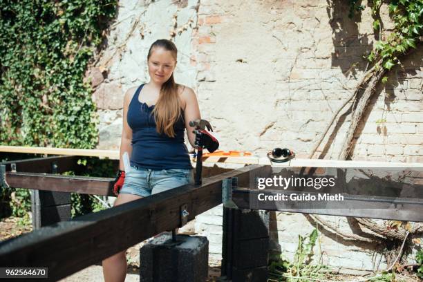 woman looking on diy garden deck. - guido mieth stock-fotos und bilder