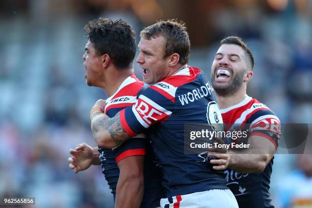 Latrell Mitchell Jake Friend and James Tedesco of the Roosters celebrate a try during the round 12 NRL match between the Sydney Roosters and the Gold...