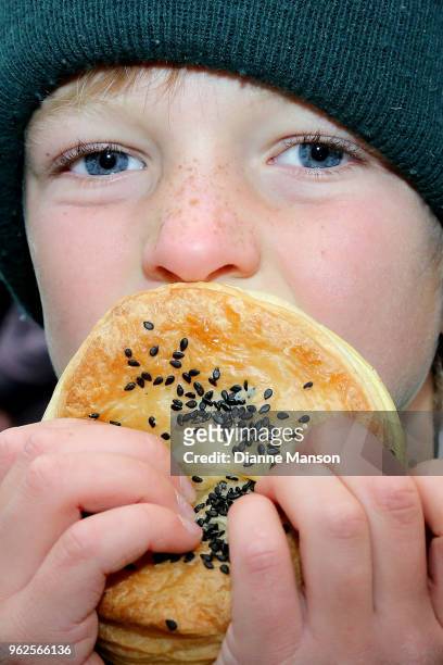 Young festival goer tries a pie during the Bluff Oyster & Food Festival on May 26, 2018 in Bluff, New Zealand. The annual event aims to showcase...