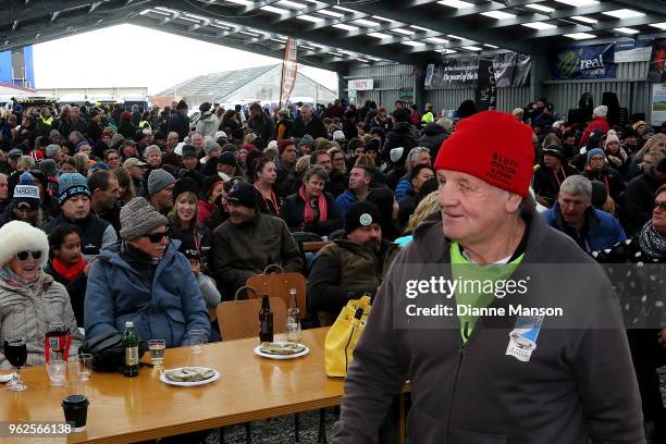 John Edminstin, Bluff Festival chairman, walks pass the festival crowd during the Bluff Oyster & Food Festival on May 26, 2018 in Bluff, New Zealand....